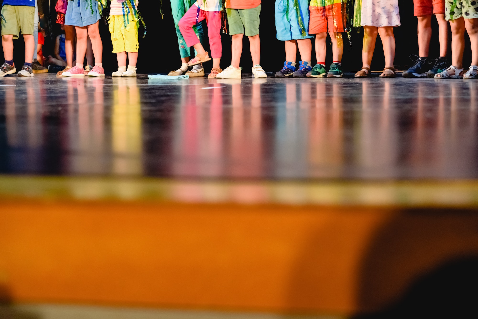 Children on a stage to represent a work in their school, unrecognizable.