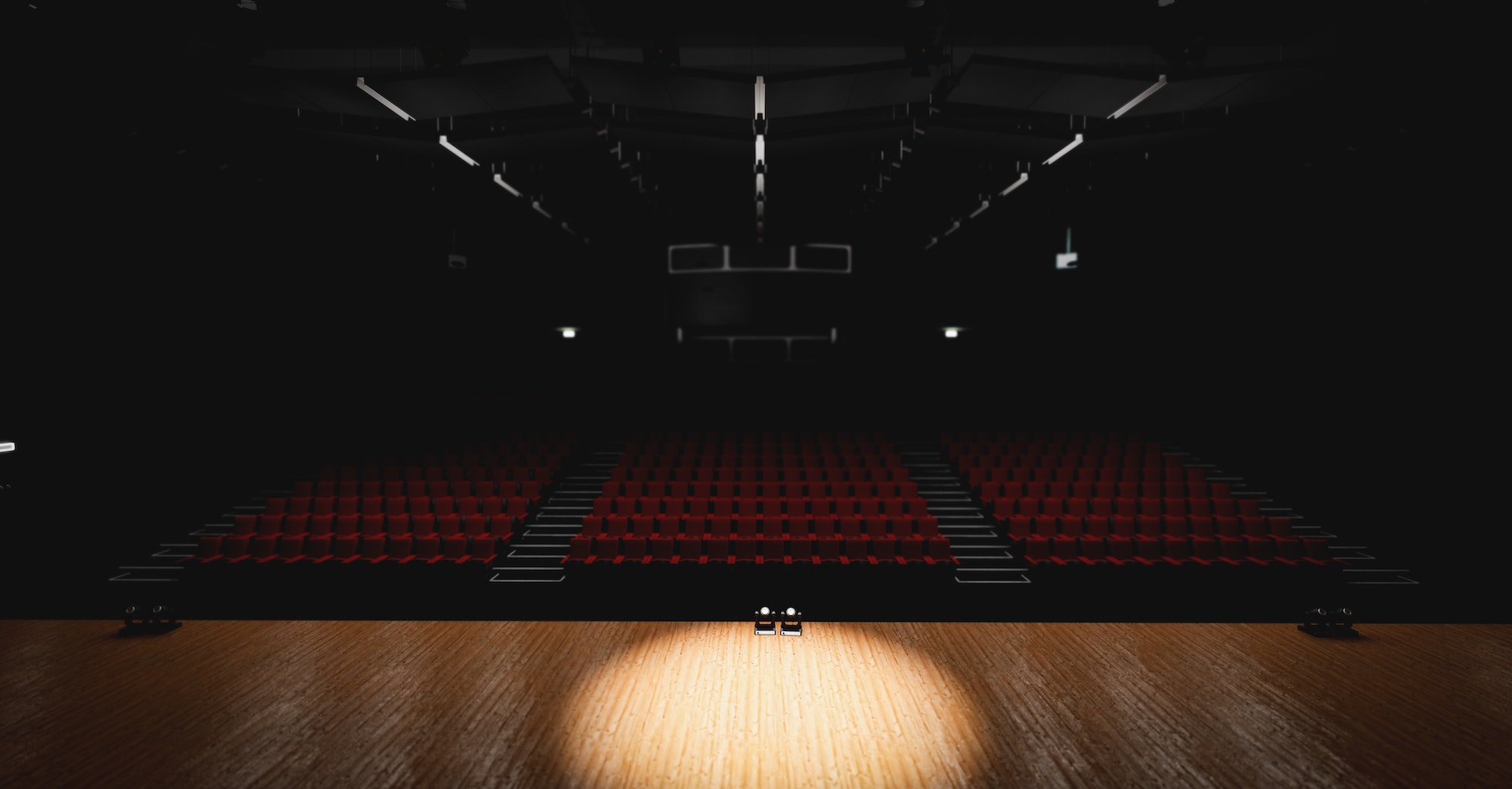 Theatre with empty stage in spotlight. Red theater curtain and seats