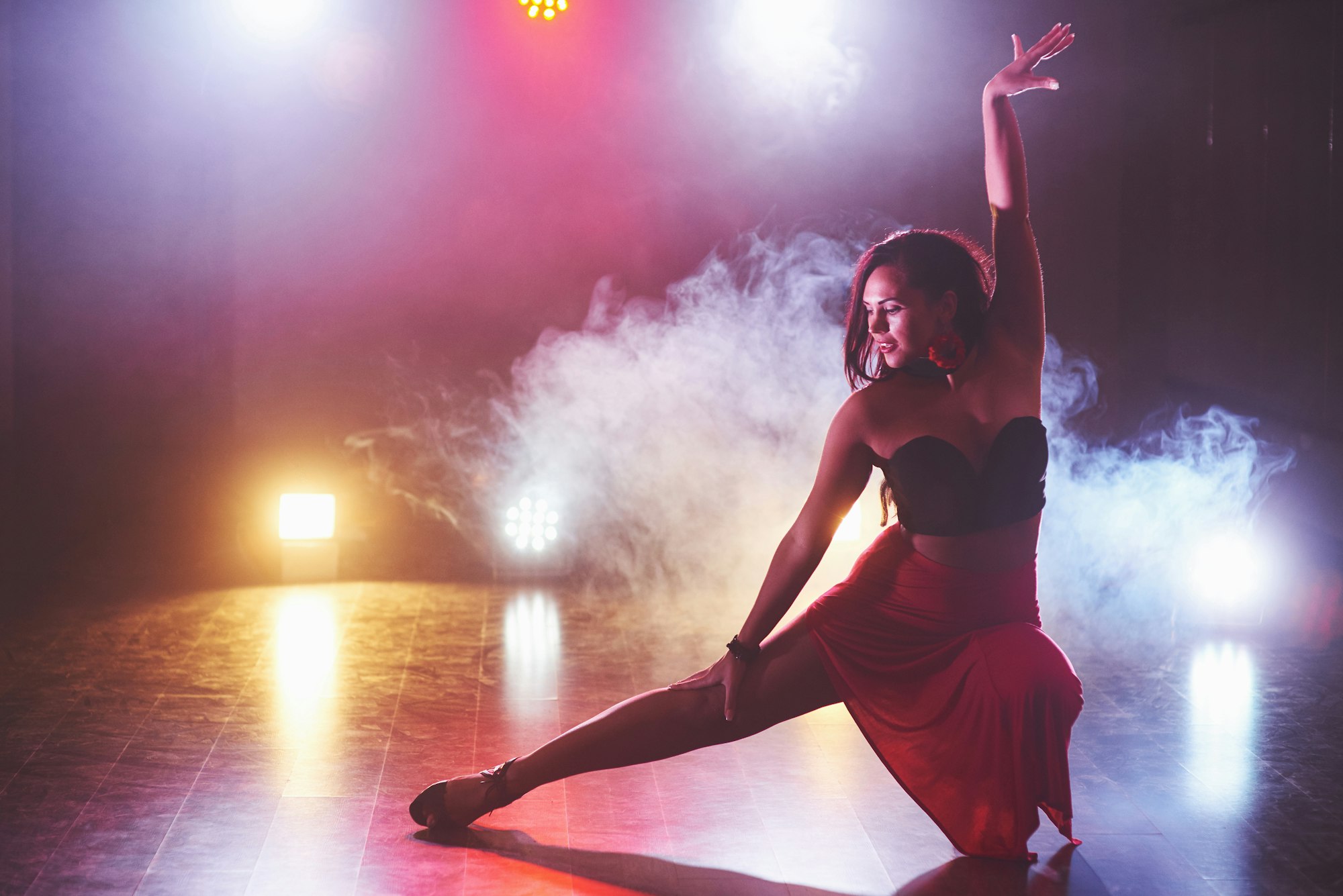 Beautiful girl dancing in the fog in the night club