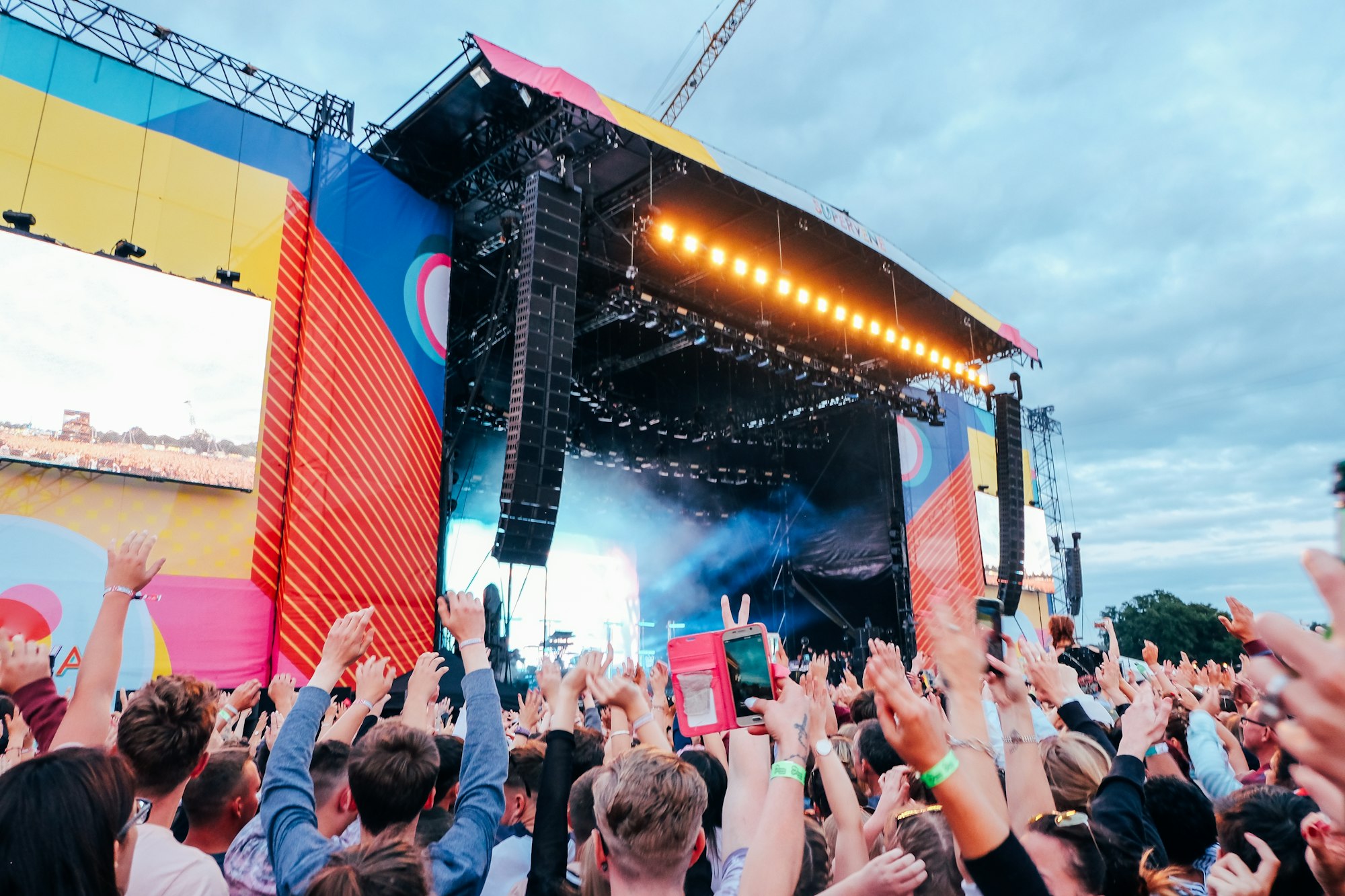 Music festival outdoor stage with crowds dancing