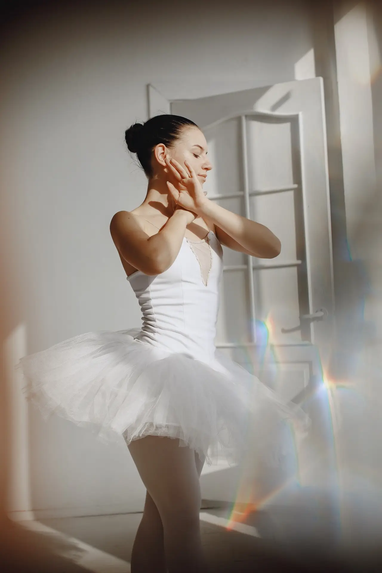 Ballerina posing in front of white background